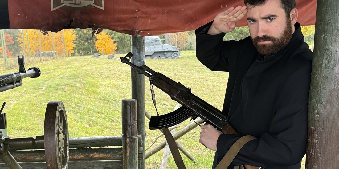 Saluting under the Stalin Line banner, AK in hand