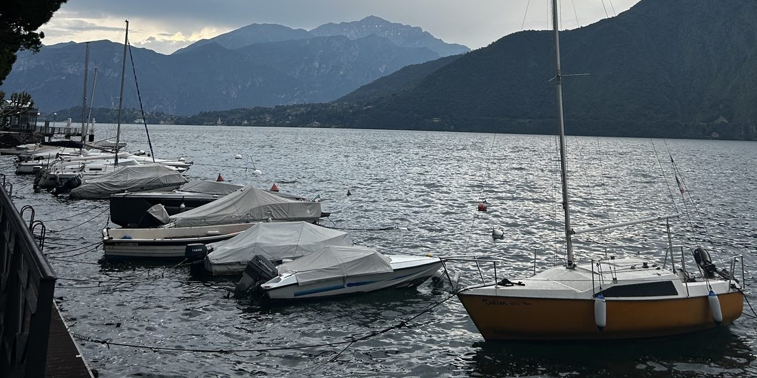 Boats on Lake Como under the mountains