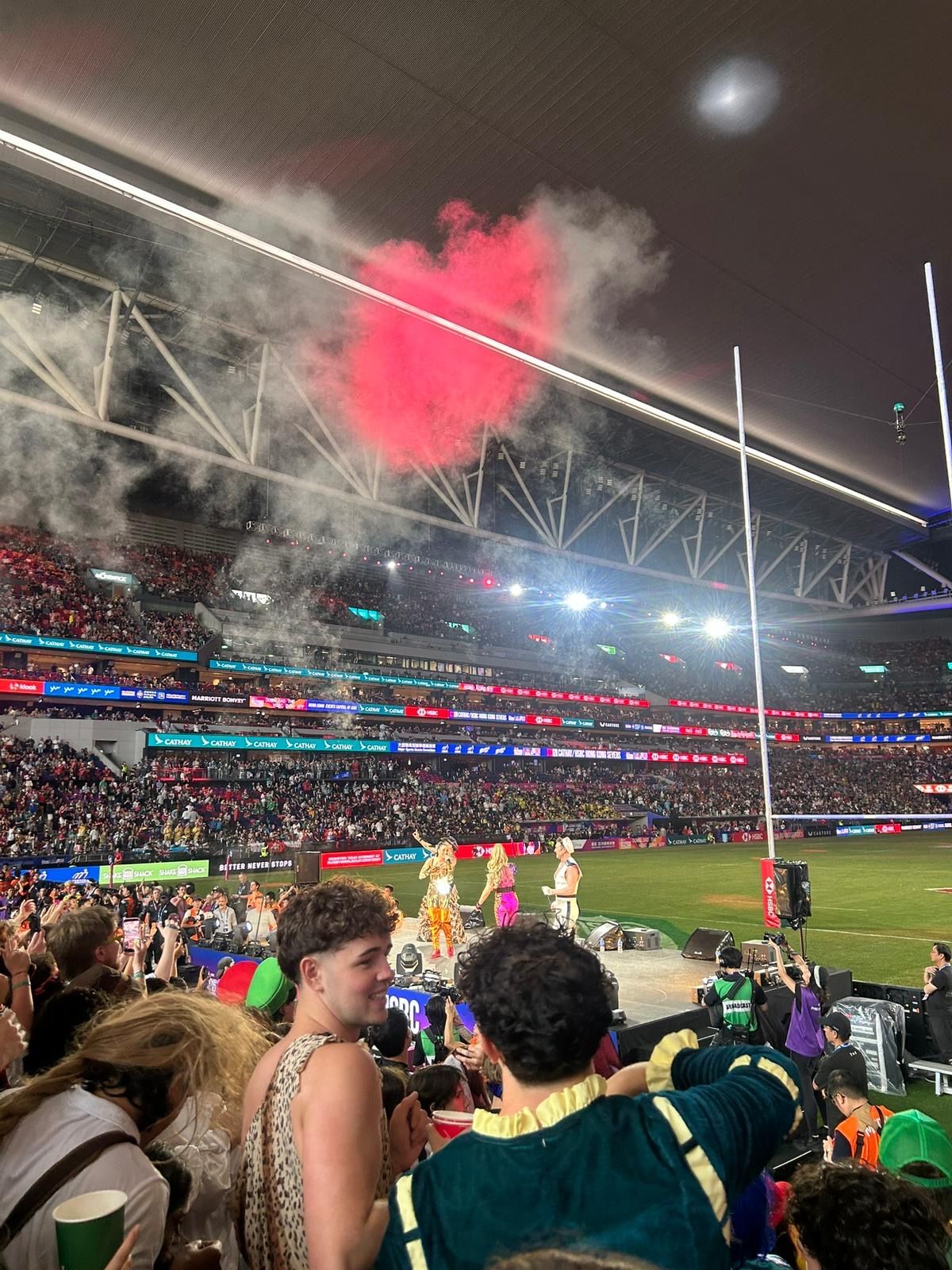 Fancy dress and pink smoke in the crowd at the Hong Kong Sevens