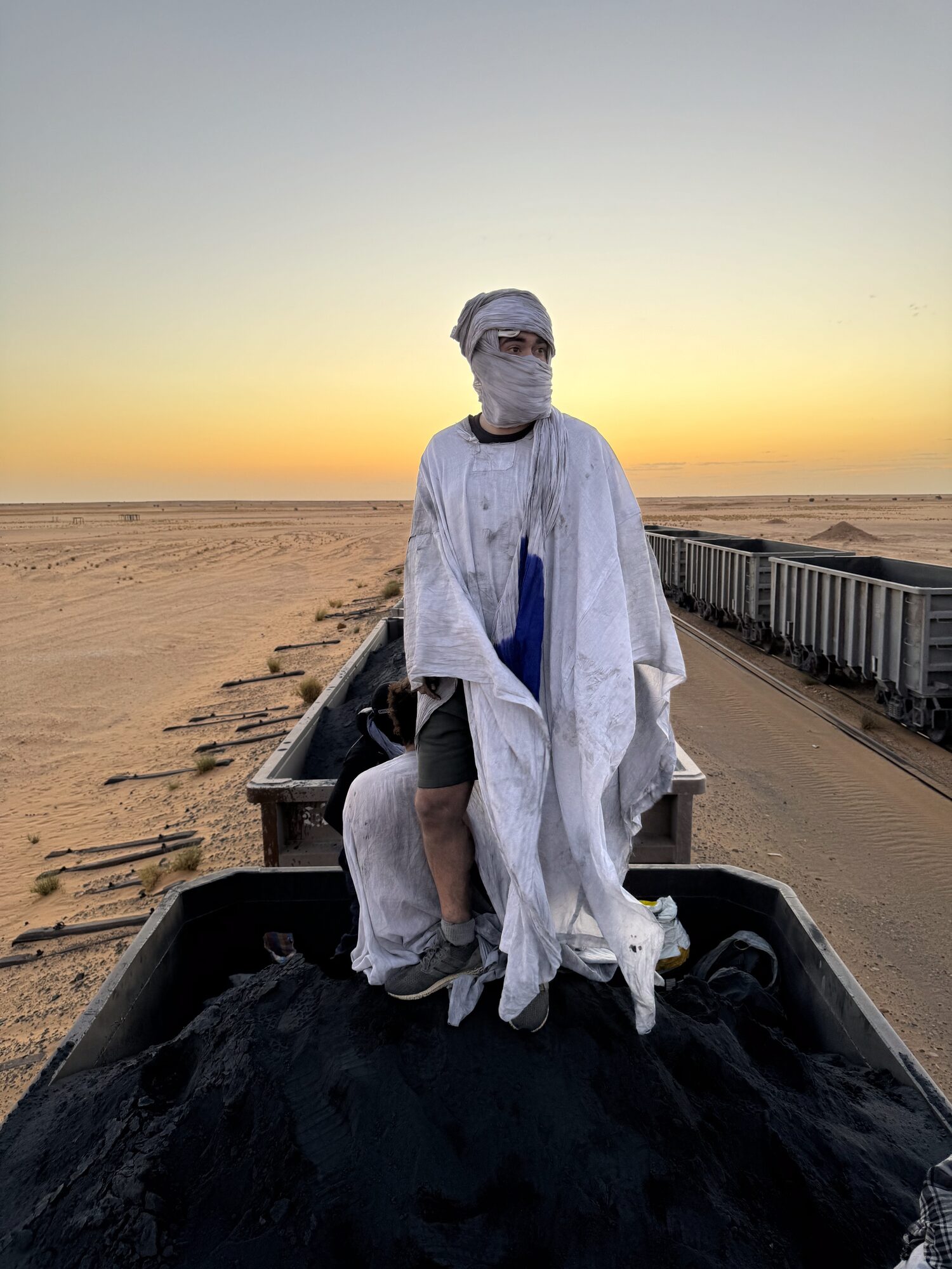 Riding on top of the Iron Ore Train at sunset, Mauritania
