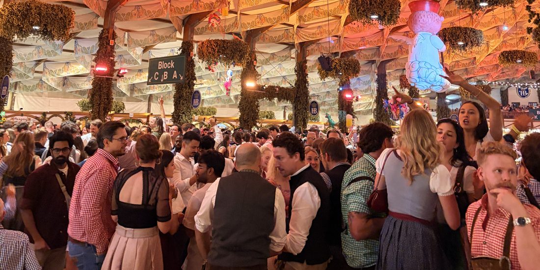 The crowd under the hop garlands inside the tent